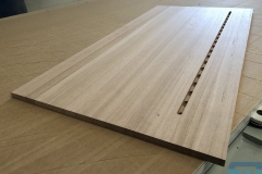 Solid timber desktop with integrated device slot and charging holes